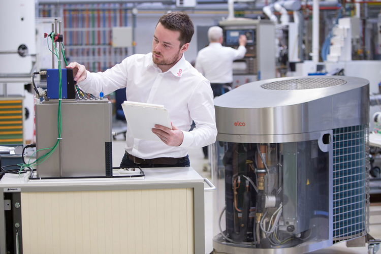 Man with a clipboard carries out tests on an ELCO heat pump