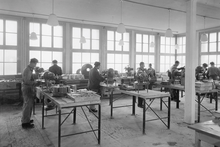 Black and white photo of ELCO employees in a production facility